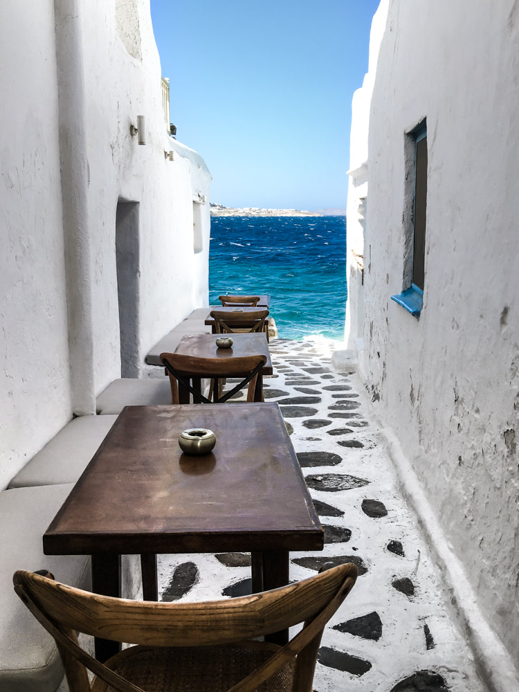 Prettiest alleys of Mykonos and best waterfront dining and bar for sunset drinks.  Kastros in Mykonos Town, Greek Islands.